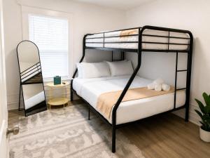 a bedroom with two bunk beds and a table at Spacious Modern 2BR Apartment Sleeps 6 in Niagara Falls