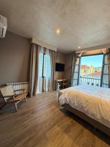a bedroom with a bed and a large window at Chateau Montchenot in Maipú +113 photos