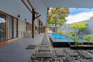 an external view of a house with a swimming pool at KyGunAya Villa in Gili Islands