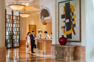 a bride and groom standing at a bar in the lobby of a hotel at Hanoi Daewoo Hotel in Hanoi +69 photos