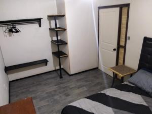 a room with a bed and a room with a door at Casa amueblada in Manuel F. Martínez