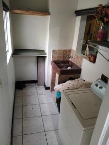 a small kitchen with a sink and a table at Casa amueblada in Manuel F. Martínez