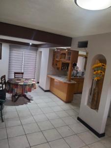 a kitchen and dining room with a table and a counter at Casa amueblada in Manuel F. Martínez