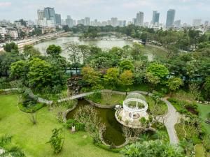 an aerial view of a park with a river and a city at Hanoi Daewoo Hotel in Hanoi