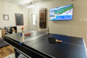 a ping pong table in a living room at Pickleball Pool Table Hot Tub FirePit King Bed in Blakeslee