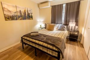 a bedroom with a bed and a large window at Pickleball Pool Table Hot Tub FirePit King Bed in Blakeslee