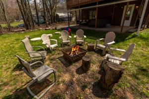 a group of chairs sitting around a fire pit at Pickleball Pool Table Hot Tub FirePit King Bed in Blakeslee