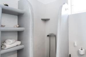 a bathroom with white towels and a shower at Olga's House kythnos D in Kithnos