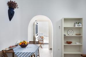 a room with a table with a bowl of fruit on it at Olga's House kythnos D in Kithnos +20 photos
