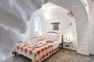 a bedroom with a bed in a white room at Olga's House kythnos D in Kithnos