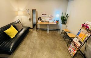 a living room with a couch and a table at Wallaby House in Kawaguchi