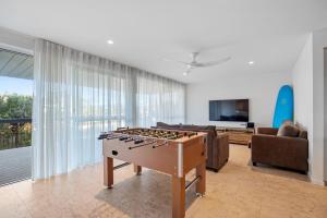 a living room with a foosball table in the middle at Free night! Pay for 2 stay for 3 in Mollymook