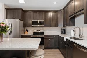 a kitchen with wooden cabinets and a counter top at 539 Bay St ⁀➷ 3BDR Lake View Penthouse Condo on West Bay ➠ 401W in Traverse City