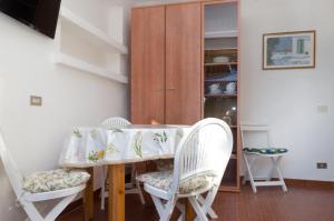 a dining room table with two chairs and a table at Villa Maria Carla in Capoliveri