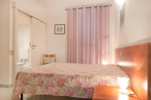 a bedroom with a bed and a table and a window at Villa Maria Carla in Capoliveri