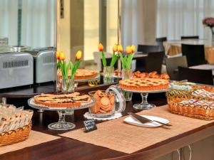 a table with pies andcakes on top at Park Hotel Cassano in Cassano dʼAdda