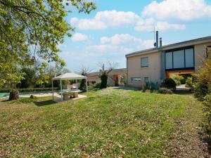 a backyard with a picnic table and a building at Elegant villa with pool in Senigallia
