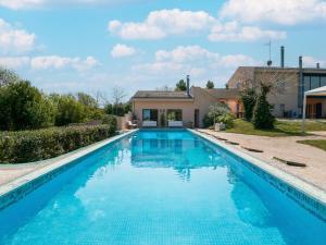 a swimming pool in front of a house at Elegant villa with pool in Senigallia