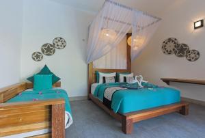 a bedroom with two beds and a window at KyGunAya Villa in Gili Islands