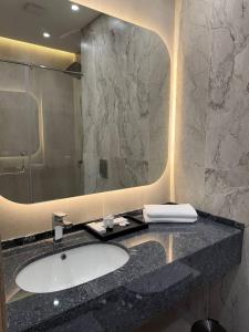 a bathroom with a sink and a mirror at Metropol Hotel Bishkek in Bishkek +50 photos