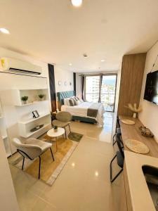a hotel room with a bed and a living room at Apartamento tipo Loft in Gaira