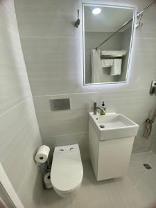 a white bathroom with a toilet and a sink at Private Pet-Friendly Casita in Phoenix +11 photos