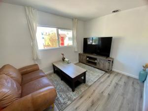 a living room with a couch and a flat screen tv at Private Pet-Friendly Casita in Phoenix
