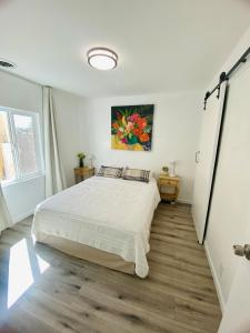 a bedroom with a bed and a painting on the wall at Private Pet-Friendly Casita in Phoenix