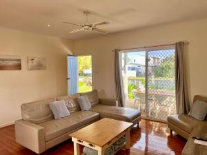 a living room with a couch and a table at SUMMER DAYSIES - Pet Friendly WiFi in Robe
