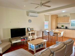 a living room with a couch and a table at SUMMER DAYSIES - Pet Friendly WiFi in Robe