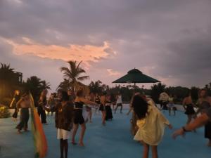 a group of people dancing on the beach at sunset at JIB Hostel RestoBar in Weligama +33 photos
