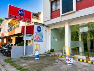 a hotel sign in front of a building at Marina Jampea Hotel in Makassar