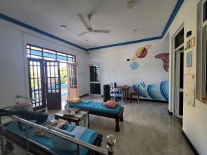 a living room with a couch and a bed at JIB Hostel RestoBar in Weligama