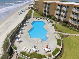 an aerial view of a resort with a swimming pool and the beach at Kingfisher Oceanfront Condo w Pool & Elevator in North Topsail Beach