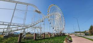a ferris wheel in a park on a clear day at Malina guest house in Bosteri +5 photos
