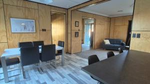 a conference room with a table and chairs and a couch at Welcome To Wansbeck in Oamaru