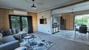a living room with a couch and a table at Welcome To Wansbeck in Oamaru