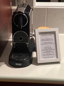a black toaster next to a picture of a sign at Boutique Coastal Beach House Cowes Phillip Island Sleeps 8 in Cowes
