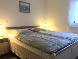 ヴァーネミュンデにあるApartment Warnemünde 19のベッドルーム1室(木製ベッド1台、枕2つ付)