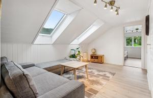 a living room with a couch and a table at Awesome Apartment In Strandebarm in Strandebarm