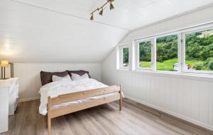 a bedroom with a bed and a window at Awesome Apartment In Strandebarm in Strandebarm