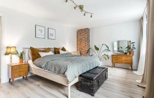 a bedroom with a bed and a brick wall at Awesome Apartment In Strandebarm in Strandebarm +28 photos