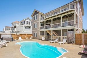 a large house with a swimming pool on a patio at 6118 - Ferrari II in Nags Head