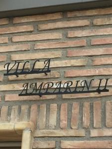 a sign on the side of a brick building at Villa Amparin II in Valentín