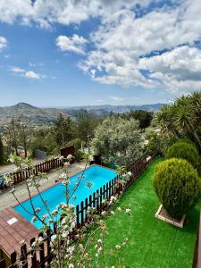 a swimming pool in a yard with green grass at Apokas Country House in Zoopiyi