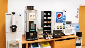a counter with a coffee maker and a refrigerator at レックスインなんば in Osaka