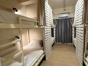 a room with two bunk beds and a window at Wonderful inn in Pattaya