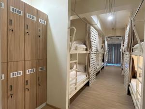 a hallway of a dorm room with bunk beds at Wonderful inn in Pattaya