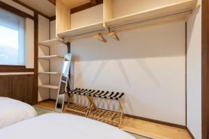 a bedroom with a closet with a ladder and a bed at nikko nagomi 和み in Nikko