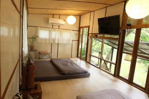 a living room with a couch and a tv in it at pannaburee resort in Ban Khanong Phra Klang (1) +129 photos